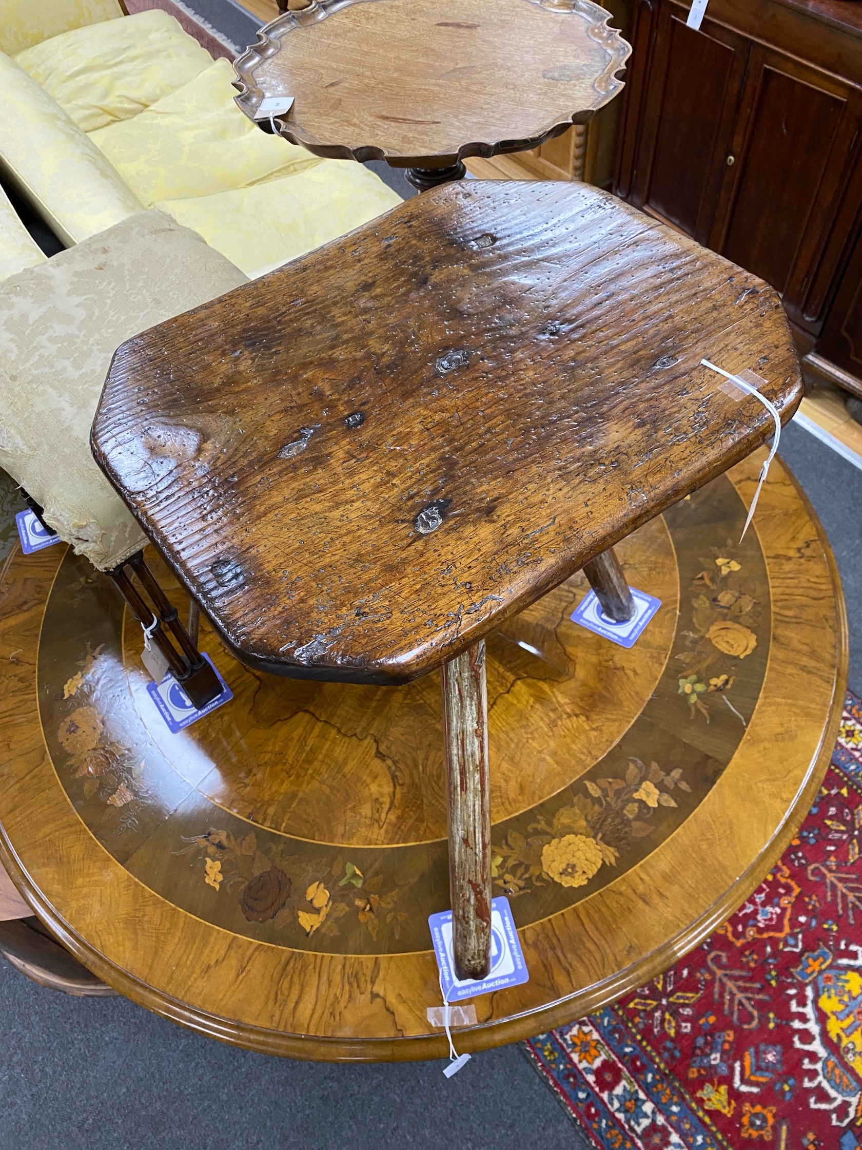 An 18th century Primitive ash and pine cricket table